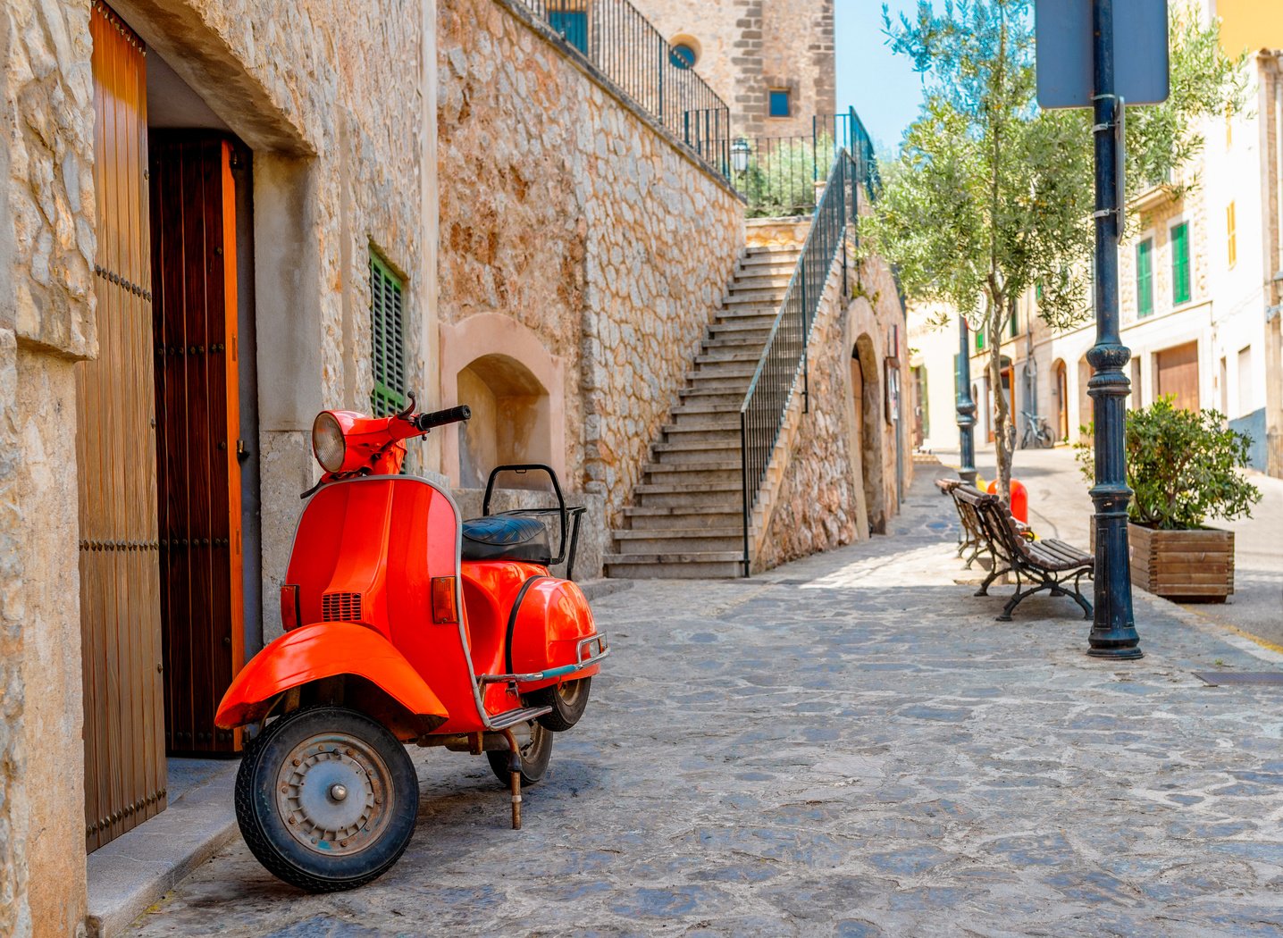 Vintage Red Motor Scooter Parked in Historic Spanish Village